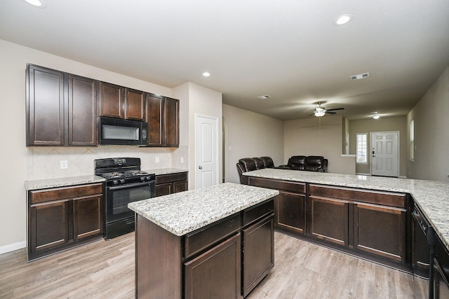 3734 Giorgio Pastel Pl, Katy, TX 77493 - kitchen featuring visible vents, ceiling fan, black appliances, light wood-style floors, and open floor plan