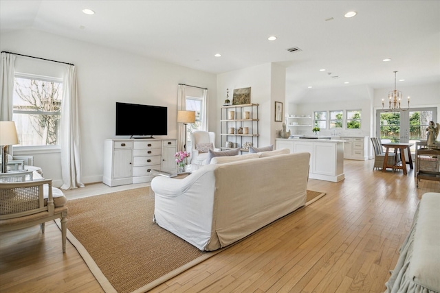 living area with recessed lighting, visible vents, plenty of natural light, and light wood-style flooring