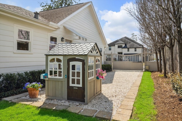 exterior space with an outdoor structure and fence