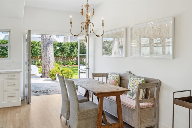 dining room featuring a wealth of natural light, light wood finished floors, and an inviting chandelier