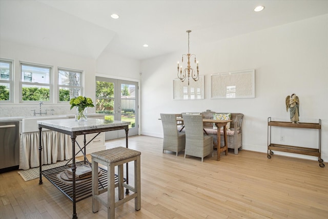 dining space with baseboards, french doors, light wood finished floors, and recessed lighting