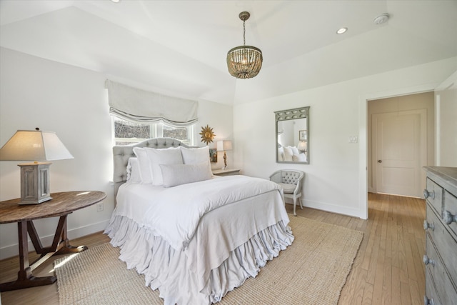 bedroom with light wood-type flooring, a notable chandelier, baseboards, and recessed lighting