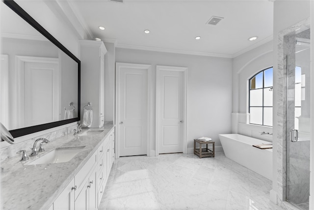 bathroom with marble finish floor, ornamental molding, a stall shower, a sink, and a freestanding tub