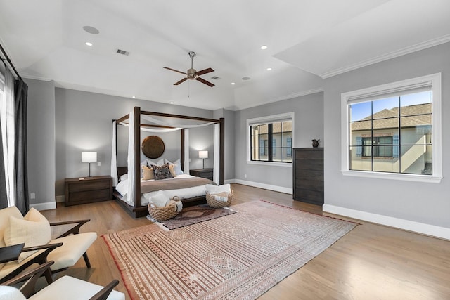 bedroom featuring baseboards, crown molding, visible vents, and wood finished floors