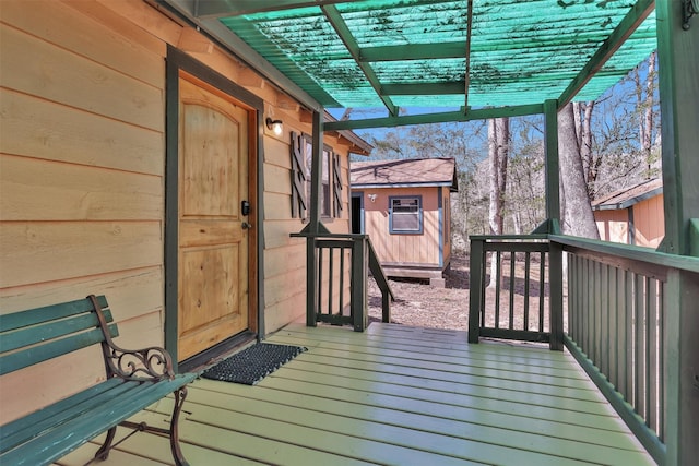 deck with an outbuilding and a pergola