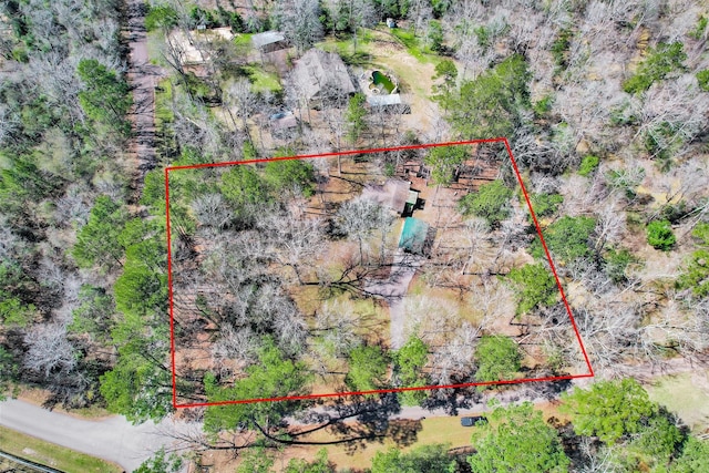 birds eye view of property featuring a view of trees