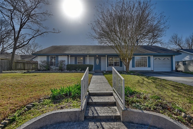 ranch-style home featuring a garage, driveway, fence, a front yard, and stucco siding