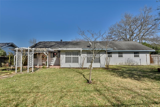 rear view of property with a pergola, fence, and a lawn