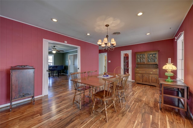 dining area featuring a notable chandelier, recessed lighting, visible vents, ornamental molding, and wood finished floors