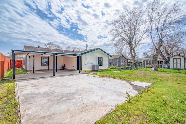 back of house featuring a patio, central AC unit, a lawn, and a fenced backyard