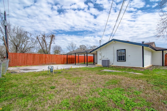 view of yard with a patio area, fence, and cooling unit