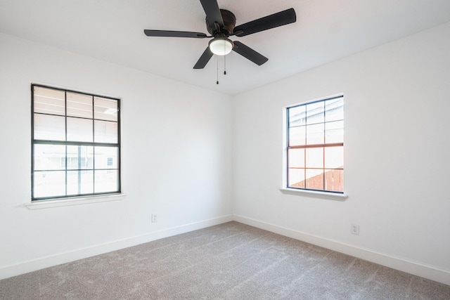 spare room featuring carpet flooring, ceiling fan, and baseboards