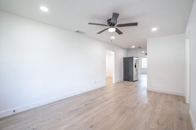 interior space with light wood-style floors, visible vents, ceiling fan, and baseboards