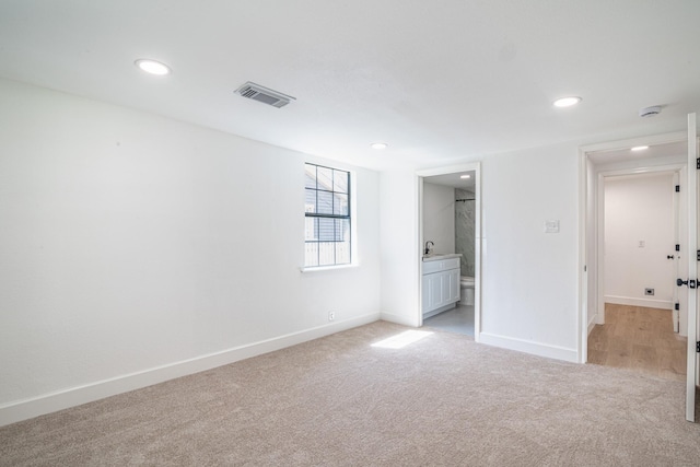 unfurnished bedroom with light carpet, recessed lighting, visible vents, and baseboards