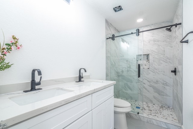 full bath with toilet, a marble finish shower, and a sink