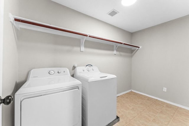 laundry room featuring laundry area, washer and clothes dryer, visible vents, and baseboards