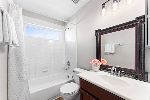 bathroom featuring toilet, visible vents, shower / bath combo with shower curtain, and vanity