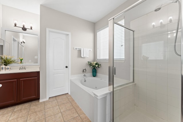 bathroom with tile patterned flooring, a garden tub, a shower stall, and vanity