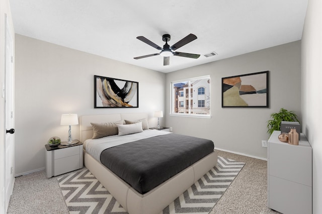 bedroom with light carpet, baseboards, visible vents, and a ceiling fan