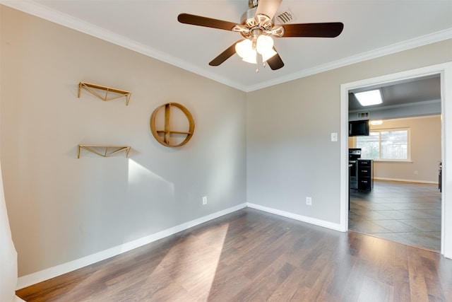 unfurnished room featuring dark wood-type flooring, ornamental molding, baseboards, and ceiling fan