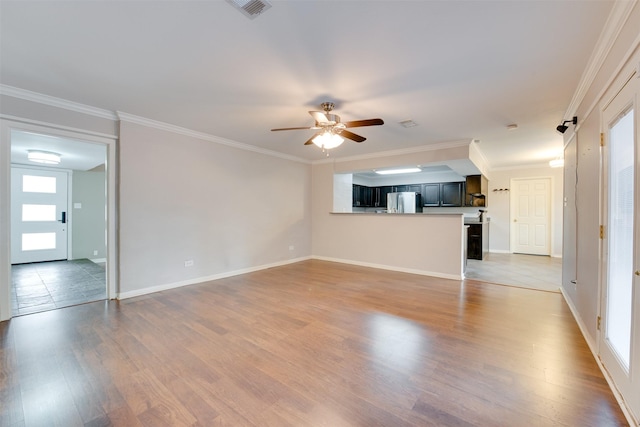 unfurnished living room featuring baseboards, visible vents, ceiling fan, crown molding, and light wood-type flooring