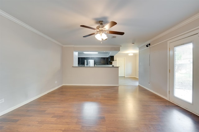 unfurnished living room with ornamental molding, ceiling fan, and wood finished floors