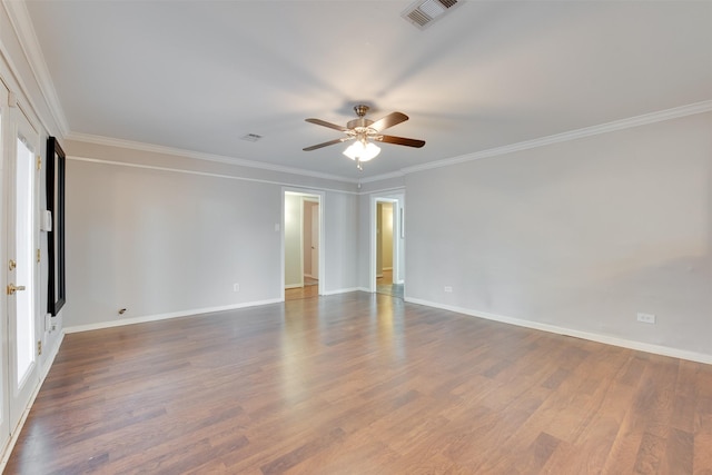 unfurnished room with baseboards, visible vents, dark wood-style flooring, and ornamental molding