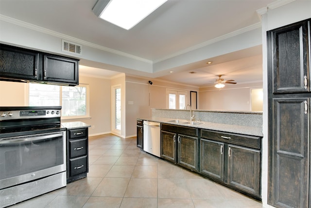 kitchen with visible vents, appliances with stainless steel finishes, ornamental molding, light tile patterned flooring, and a sink