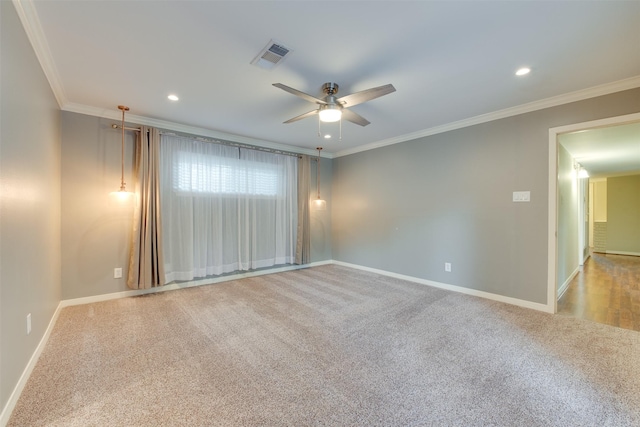 unfurnished room with baseboards, a ceiling fan, visible vents, and crown molding