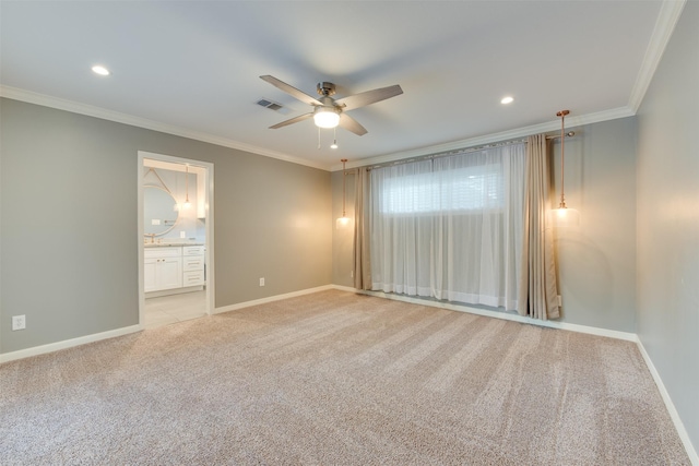 spare room with light carpet, ornamental molding, visible vents, and baseboards