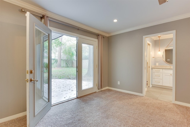 entryway featuring plenty of natural light, ornamental molding, and light colored carpet