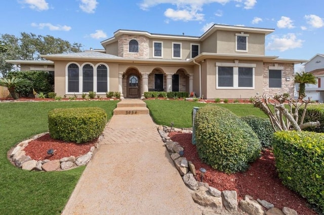 view of front of house with stucco siding, stone siding, and a front yard