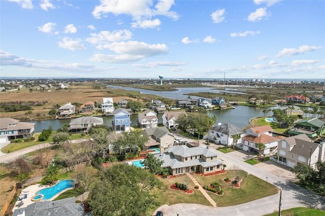 birds eye view of property with a water view and a residential view