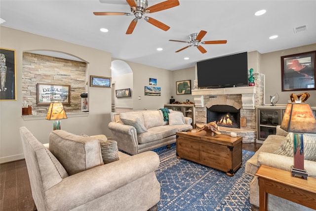 living room featuring a fireplace, visible vents, wood finished floors, and recessed lighting