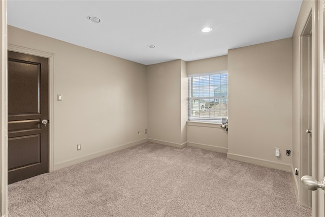 carpeted spare room featuring recessed lighting and baseboards