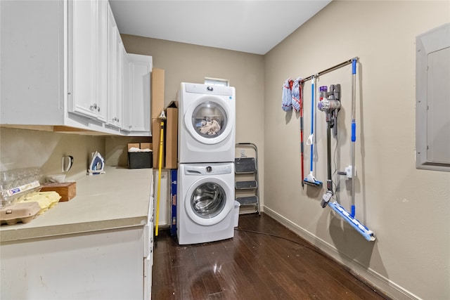 washroom featuring baseboards, dark wood-style flooring, stacked washer and clothes dryer, and electric panel