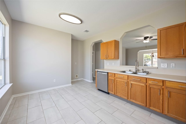 kitchen with light countertops, visible vents, dishwasher, and a sink