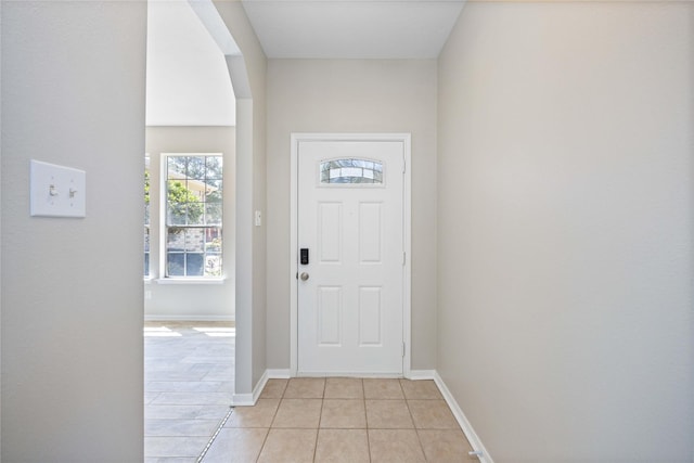 entrance foyer featuring light tile patterned floors and baseboards