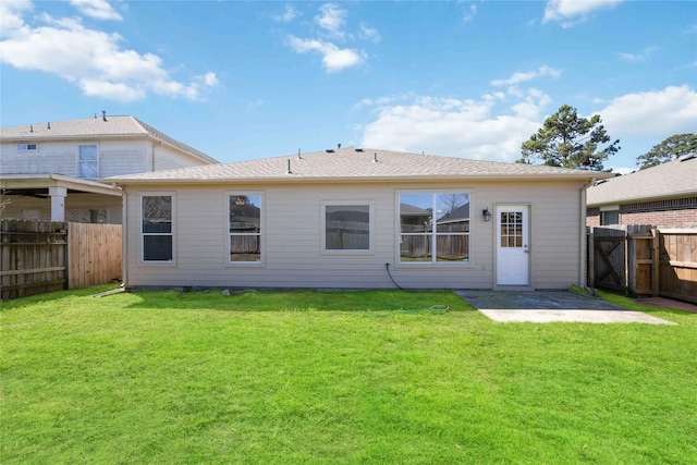 back of house with a patio area, a fenced backyard, and a lawn