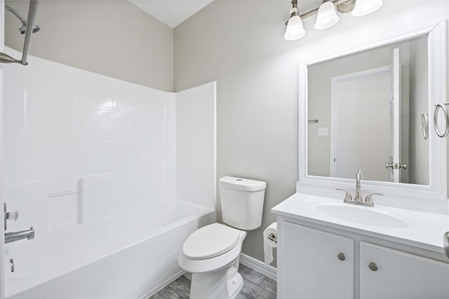 full bathroom featuring baseboards, shower / bathing tub combination, vanity, and toilet