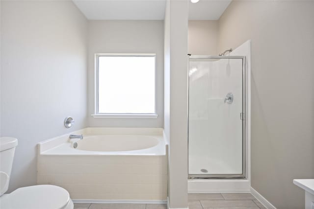 bathroom featuring toilet, a shower stall, and a bath