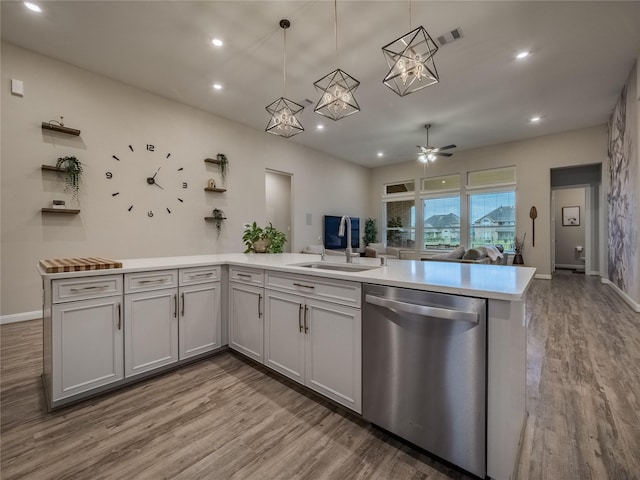 kitchen featuring a peninsula, visible vents, open floor plan, light wood-type flooring, and dishwasher