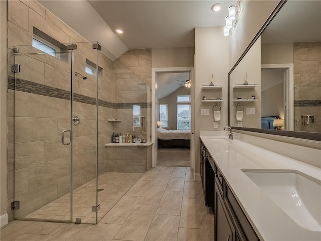 full bath with a stall shower, lofted ceiling, ensuite bath, ceiling fan, and a sink