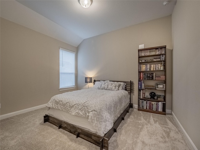 bedroom featuring carpet floors, baseboards, and lofted ceiling