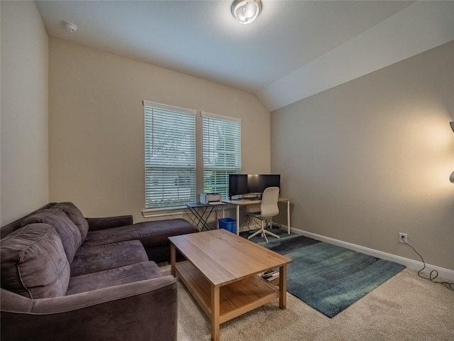 living room featuring carpet floors, baseboards, and lofted ceiling