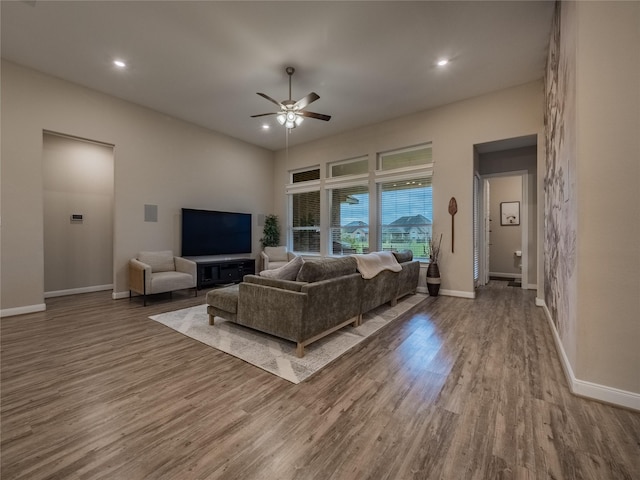 living area featuring recessed lighting, wood finished floors, and baseboards