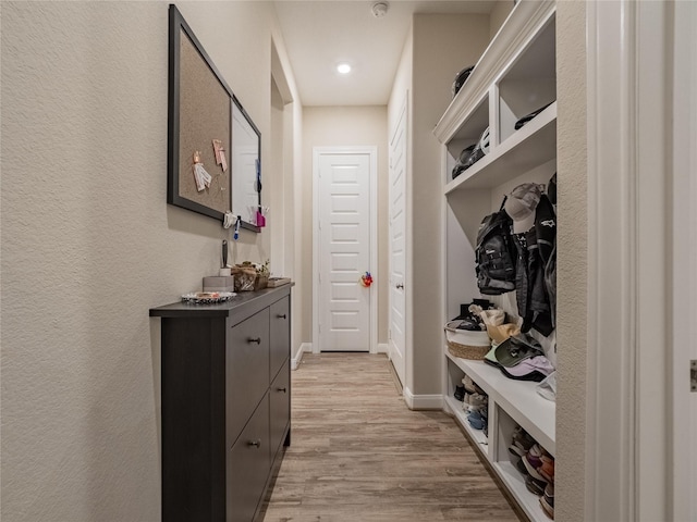 mudroom with baseboards and light wood-style floors