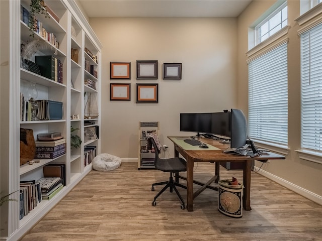 office space featuring baseboards and wood finished floors