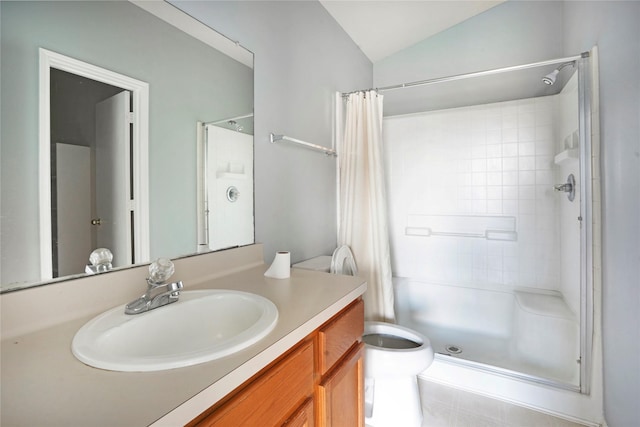 full bathroom with toilet, a shower stall, vaulted ceiling, and vanity