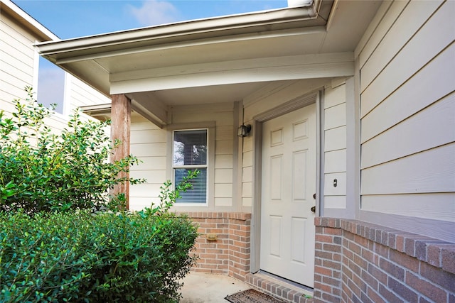 property entrance with brick siding